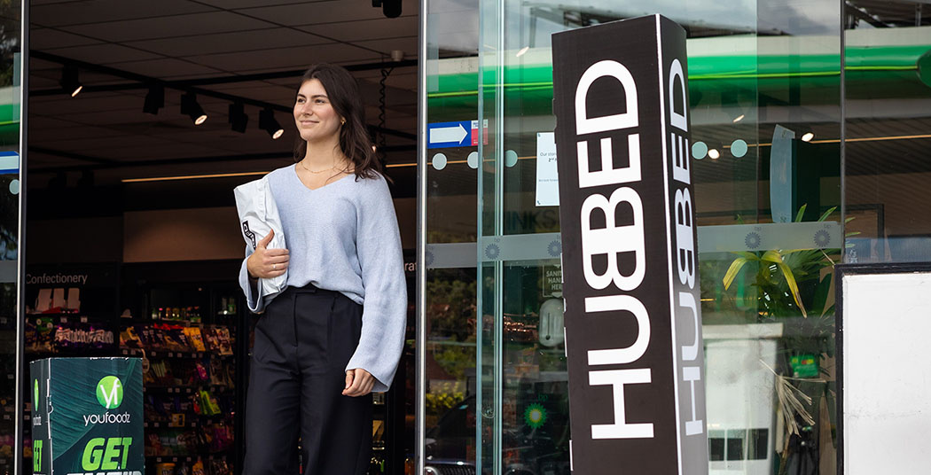 woman picking up parcel at hubbed parcelpoint